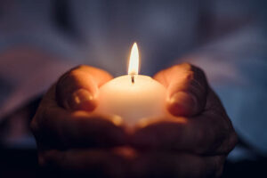 Man Holding A Burning Candle